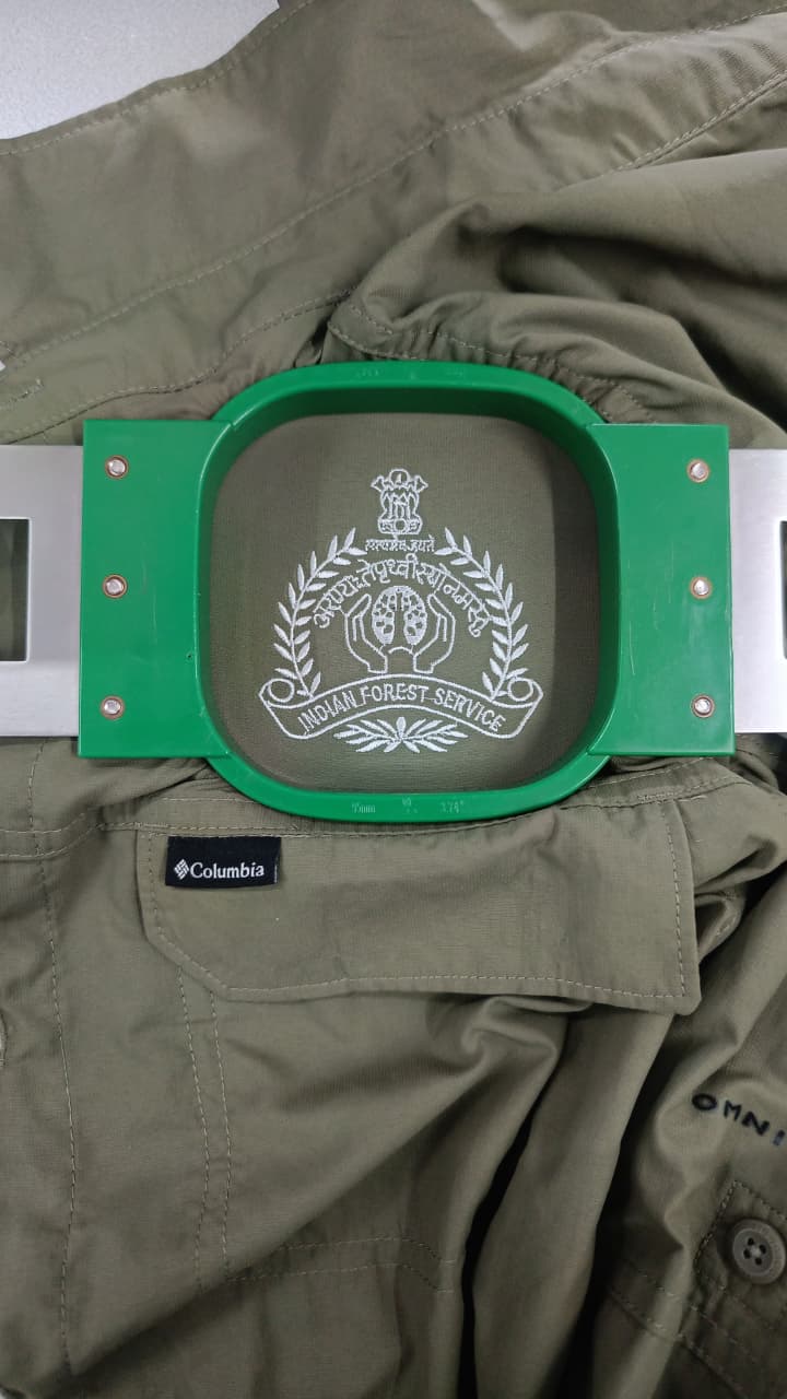Indian Forest Service crest embroidered on an olive uniform shirt