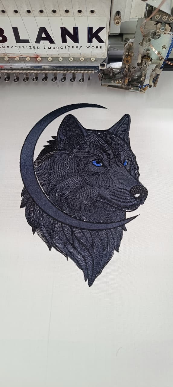 Detailed wolf and crescent moon embroidery in navy thread