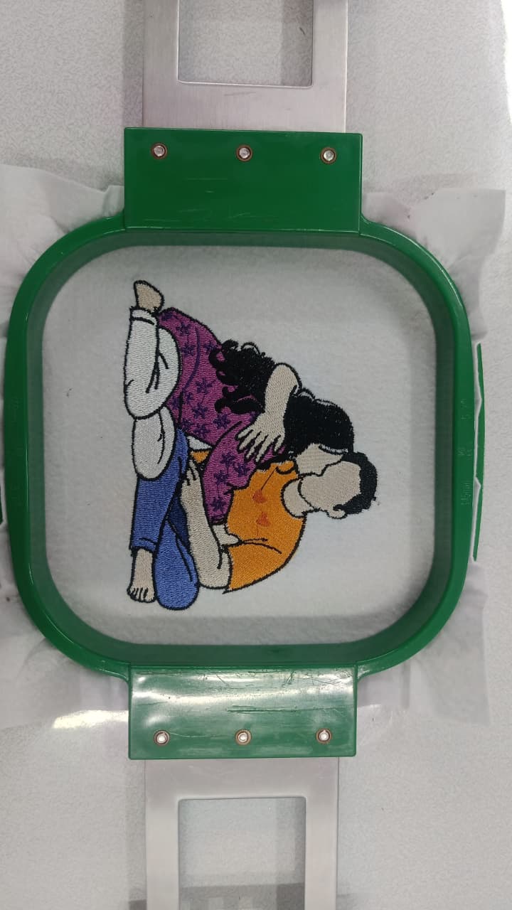 Colourful cartoon character embroidery in a green hoop
